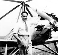 Juan de la Cierva standing next to the first Autogyro he invented