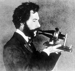 Alexander Bell using the first telephone he invented