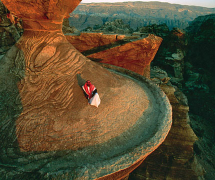 A Bedouin poses on the ruins of the ancient Jordanian city of Petra